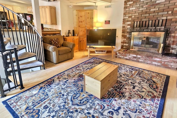 spacious living room with wood burning fireplace