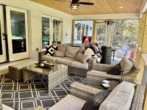 Screened in porch with gas fireplace, TV, 2 heaters and a ping pong table. 