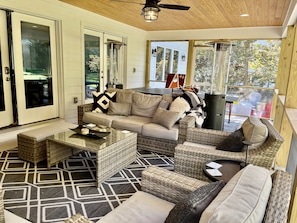 Screened in porch with gas fireplace, TV, 2 heaters and a ping pong table.