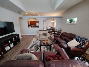 Beautiful arches and angles hover over comfy Lazy Boy recliners to watch 65" TV