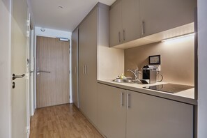 Compact kitchenette with modern appliances, ideal for simple meals during your stay.