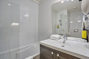 Stylish bathroom with modern vanity, clean white fixtures, and inviting tile accents.