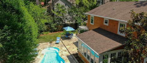 The backyard oasis is truly one-of-a-kind w/ pool, patio, dining area, and grill
