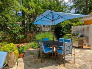 Outdoor dining area beside the pool.  There is also a grill and outdoor shower.