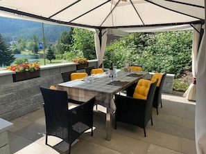 Outdoor garden seating with the view over the Lake of St. Moritz