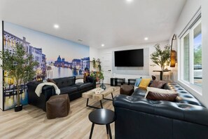 Italy inspired design with leather couches and 75" TV