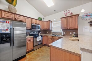 Fully equipped kitchen with space to gather around the breakfast bar