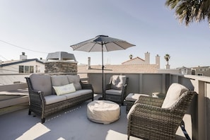 Elevate your vacation experience on the roof deck with cozy furniture + fire pit