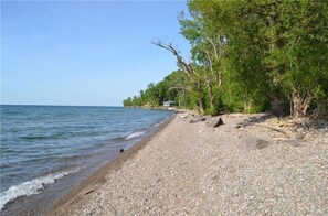 Beach mostly made up of small pebbles which faces  Lake Ontario 