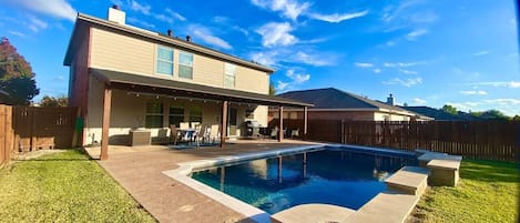 Guests can enjoy the spacious yard, patio, pool, and grill!