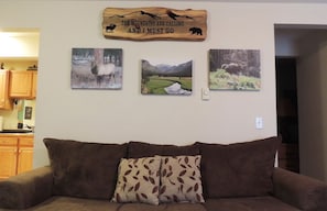 Livingroom with plenty of seating and photographs of the local wildlife