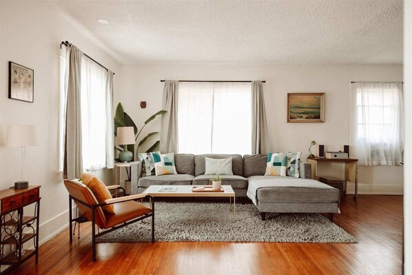 Make special memories in our spacious California craftsman living room. Stylish decor, beautiful light, cozy furniture, record player, bluetooth speaker and Roku TV. Open floor plan for your connection and comfort.