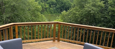 Enjoy the spacious deck with great lake views and cozy seating!  Picture during summer.