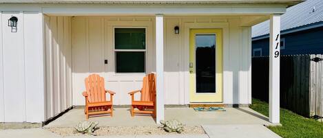 two adirondack chairs on the front patio