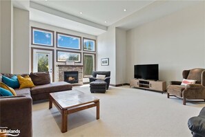 Living Room with 12" Ceilings, TV, fireplace