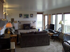 LIVING ROOM AS SEEN FROM THE KITHEN, DINING AREA TO FIREPLACE