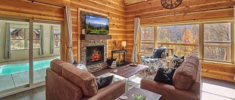 Cozy living room with electric fireplace, gorgeous views and access to the indoor pool!