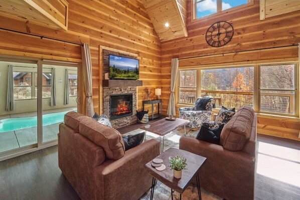 Cozy living room with electric fireplace, gorgeous views and access to the indoor pool!