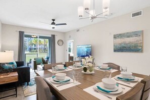 Modern open concept of living room, dining room and kitchen with island!#Disney #Parks #kingdom #springs #StoreyLake #Apartment #Vacation #Rental #waterpark #Kissimmee #Orlando #universal #citywalk