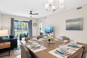 Modern open concept of living room, dining room and kitchen with island!#Disney #Parks #kingdom #springs #StoreyLake #Apartment #Vacation #Rental #waterpark #Kissimmee #Orlando #universal #citywalk