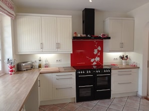 Spacious, well equipped kitchen.  Range has 2 electric ovens, grill & 7 gas hobs