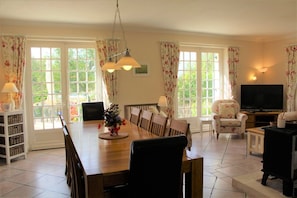 Open plan living/dining area.  Comfy seating around TV & large oak table for 10