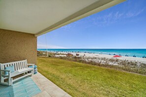 Patio | Breathe Easy Rentals - Bench seating while you enjoy a morning cup of coffee.