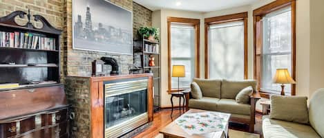 Our living room has bright bay windows overlooking the street, and a beautiful (decorative!) fireplace - it's an ideal place to sit and read, or converse