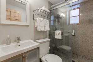 Down the hall is the full sized bathroom with a very roomy stand up shower!