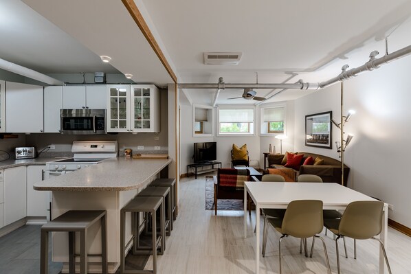 At the front of the apartment is a spacious, open-concept living/dining/kitchen area