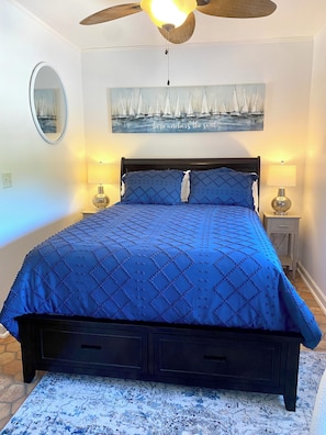 Comfortable queen bed with storage drawers in the footboard.