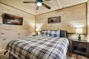 The downstairs bedroom includes a king bed with a memory foam mattress and a smart tv.