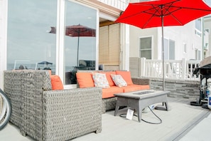 Patio lounge is ocean front above the boardwalk. Couches, table, umbrella, bbq.