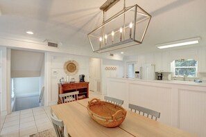 Kitchen & Dining – St. Simons Vacation Rental with Coffee Statio - Light and open dining area with a full kitchen, coffee station, and seating for six—perfect for pancake breakfasts or post-beach takeout. Bright, white finishes and coastal touches bring the island charm inside.