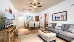 The grand living room with open floorplan to the dining area.