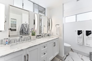 Dual vanity and sinks. Newly redesigned and renovated bathroom. Nook style toilet for privacy, and a modern and clean look. The large windows are high enough for privacy, but wide enough to let in all the natural light.