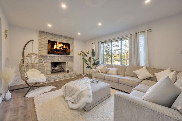 Living Room with indoor Fire place and 60inch tv.
