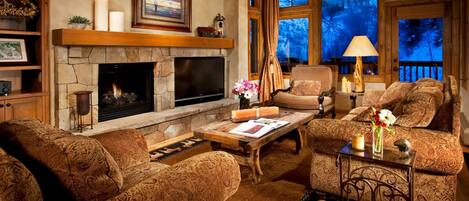 Relax in the luxurious living area, complete with fireplace. Please note that views may vary.