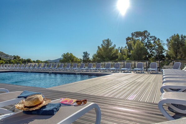 Lounge in the sun by the outdoor pool.