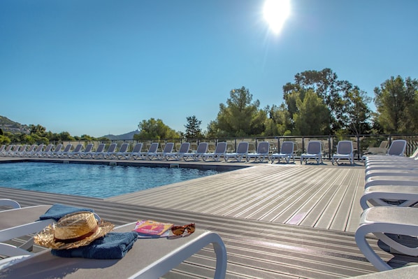 Lounge in the sun by the outdoor pool.
