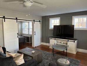 First floor family room with a 65 inch tv with both cable and streaming availabe