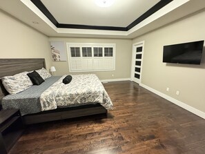 Room 1 - Master bedroom, with Smart TV, study table, and chair - another view
