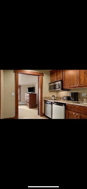 Suite Kitchenette looking into full bedroom