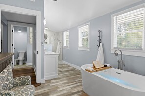 Luxurious master bathroom w/ rain shower head, lighted jetted tub and fireplace