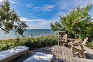 Front seaside deck with lounges, chairs and dining table