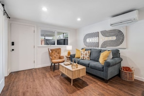Cozy living room with comfortable sofa (sofa bed) and side chair.