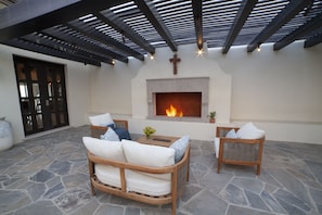 Embrace warmth and intimacy in a charming courtyard with a fireplace