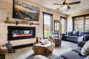 The picture doesn't do justice to the feeling of walking into this living room. It's simply beautiful. Living room with floor-to-ceiling windows that maximize sunlight.