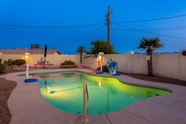 Immerse yourself in the beauty of a lit-up pool at night.
