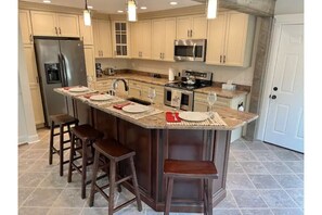 Fully stocked kitchen with breakfast bar